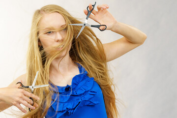 Girl with scissors for haircutting - 784514013