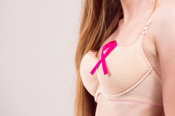 Woman chest in bra, pink cancer ribbon - 784514260