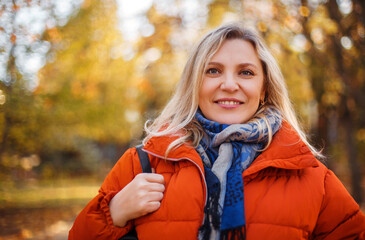 Cheerful woman in autumn park