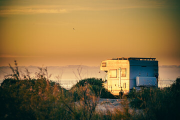 Fototapeta na wymiar Caravan on nature in the morning at sunrise