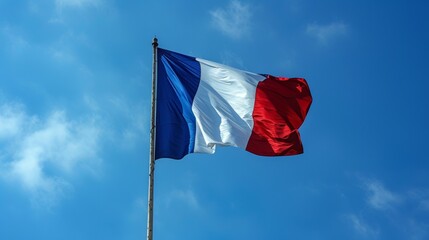 Naklejka na ściany i meble French flag waving against blue sky, copy space