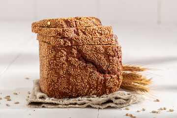 Small loaf of rye bread baked in a rustic kitchen.