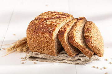 Healthy loaf of rye bread baked in a rustic kitchen.