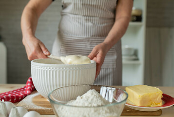 Mixing dough or batter by a woman in the kitchen