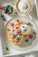 Hot and sweet waffles with with raspberries and blueberries.