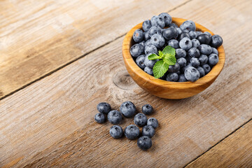 Freshly picked blueberries in a wooden bowl. Healthy berry, organic food, antioxidant, vitamin