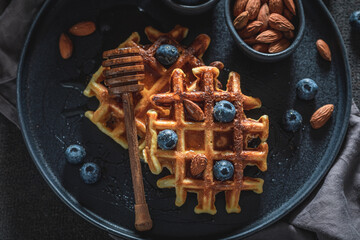 Sweet dark waffles made of berries, almonds and cocoa.