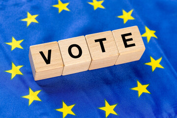 Voting in European Union Countries, Concept, Word Vote written on wooden blocks inside the EU flag - 784533070