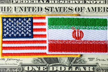 Flags of the USA and Iran against the background of the US dollar, financial concept, the impact of...
