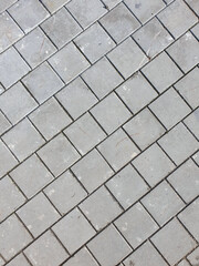 Pavement surface made of stones located diagonally in the frame