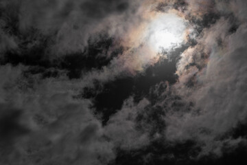 Night sky with moon behind clouds