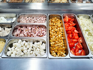 An abundant buffet featuring a variety of foods such as tomatoes and cheese