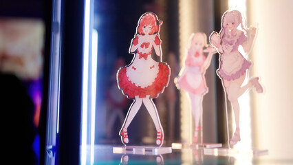 Three anime maid girl figures merchandise inside the glass cabinet lighted with LED strips