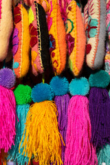 Vertical screen of Original Mexican handicrafts in colorful wool with vibrant tassels, detailed embroidery for creative decorating                            