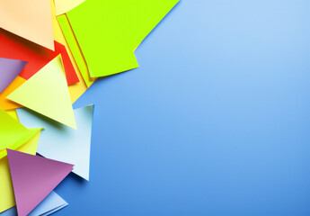 Background with pieces of paper with geometric shapes in vibrant colors