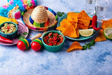 Traditional Mexican food nachos, salsa, guacamole, tequila.