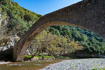 View of the historic stone bridge of Viniani at Agrafa mountains in central Greece - 784570277
