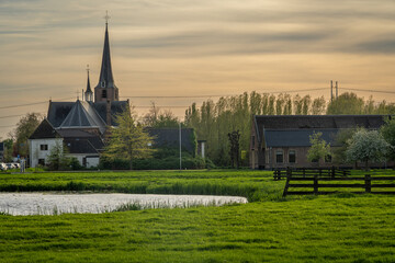 Village of Koudekerk aan den Rijn, dutch reformed church seen from the farmland