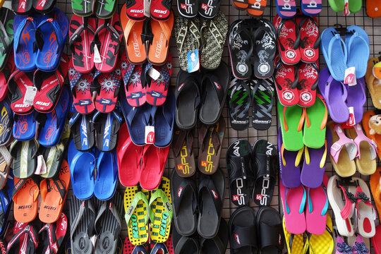 Colorful slippers hang on the road side