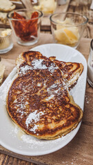 Fresh pancakes on white plate with sugar