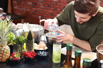 The process of preparing an alcoholic cocktail.  Nightlife, night bar atmosphere. Recipe for...