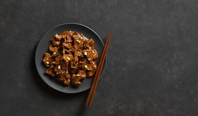 Asian style beef with soy sauce, green onion and sesame seeds
