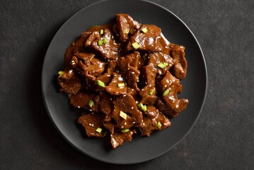 Asian style beef with soy sauce, green onion and sesame seeds