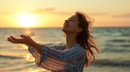 Happy woman standing with open arms on the beach at sunset. success concept,
