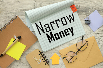 NARROW MONEY stationery and calculator on financial chart. text on notepad page with spiral