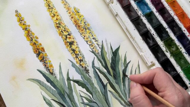 Female hand painting with brush aquarelle watercolor floral art video. Palette on background. fields meadow wild flowers and grasses. Green yellow overflowing colors. Close up Full HD