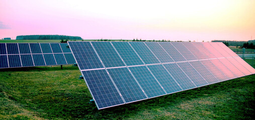 Solar panels at dusk in an open field
