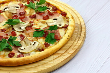 Supreme Pizza with pepperoni, mushrooms and mozzarella cheese just from oven, copy space. Fresh homemade pizza.