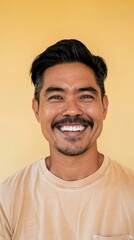 Smiling Man with Mustache Against Yellow Background