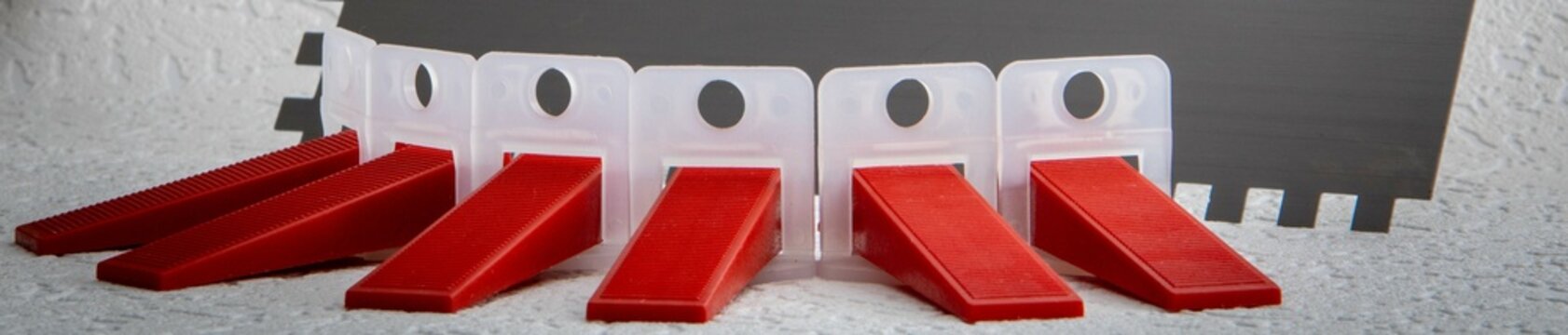 Tile Leveling System Components The image showcases essential tools for precise tile installation, featuring a tile leveling system designed to ensure uniform flatness and prevent lippage. 