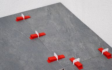 Tile Leveling System Components The image showcases essential tools for precise tile installation,...