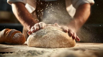 Afwasbaar Fotobehang Brood baker kneads dough on a floured surface, preparing it for baking fresh bread