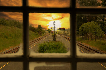 Rhyd Ddu narrow gauge railway station through a window at sunset. Part of the Welsh Highland...