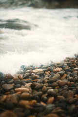 stones on the shore hitting by waves