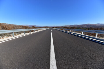The open road. Highway. New asphalted road. - 784611205