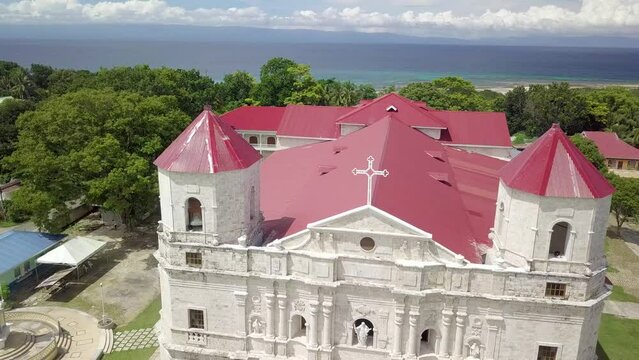 Loon, Bohol, Philippines - Aerial of the rebuilt Our Lady of Light Church, commonly known as Loon church, with the Bohol strait behind.