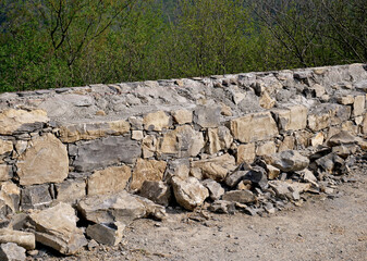Renovation of a low wall with stone and concrete