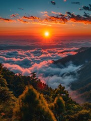 A beautiful sunset over a mountain range with a large sun in the sky. The sky is filled with clouds, creating a serene and peaceful atmosphere