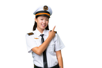 Airplane pilot Asian woman over isolated background pointing to the side to present a product