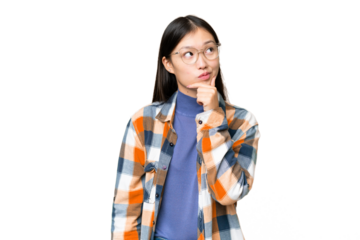 Young Asian woman over isolated chroma key background having doubts and with confuse face expression