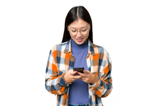 Young Asian woman over isolated chroma key background sending a message with the mobile