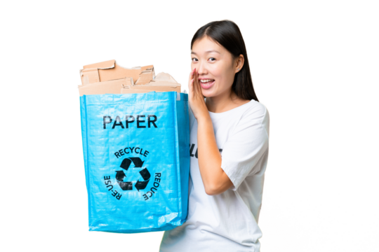 Young Asian woman holding a recycling bag full of paper to recycle over isolated chroma key background whispering something