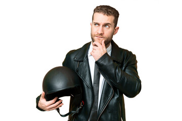 Business man with a motorcycle helmet over isolated chroma key background having doubts and thinking