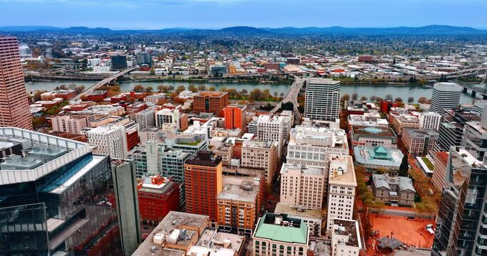 Scenery of Portland, Oregon, the USA divided by the Willamette River. Modern city view with densely built architecture from top.