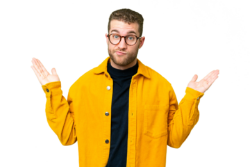 Young handsome blonde man over isolated chroma key background having doubts while raising hands