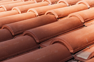 Clay tile roof. A closeup of brown tiles on a roof